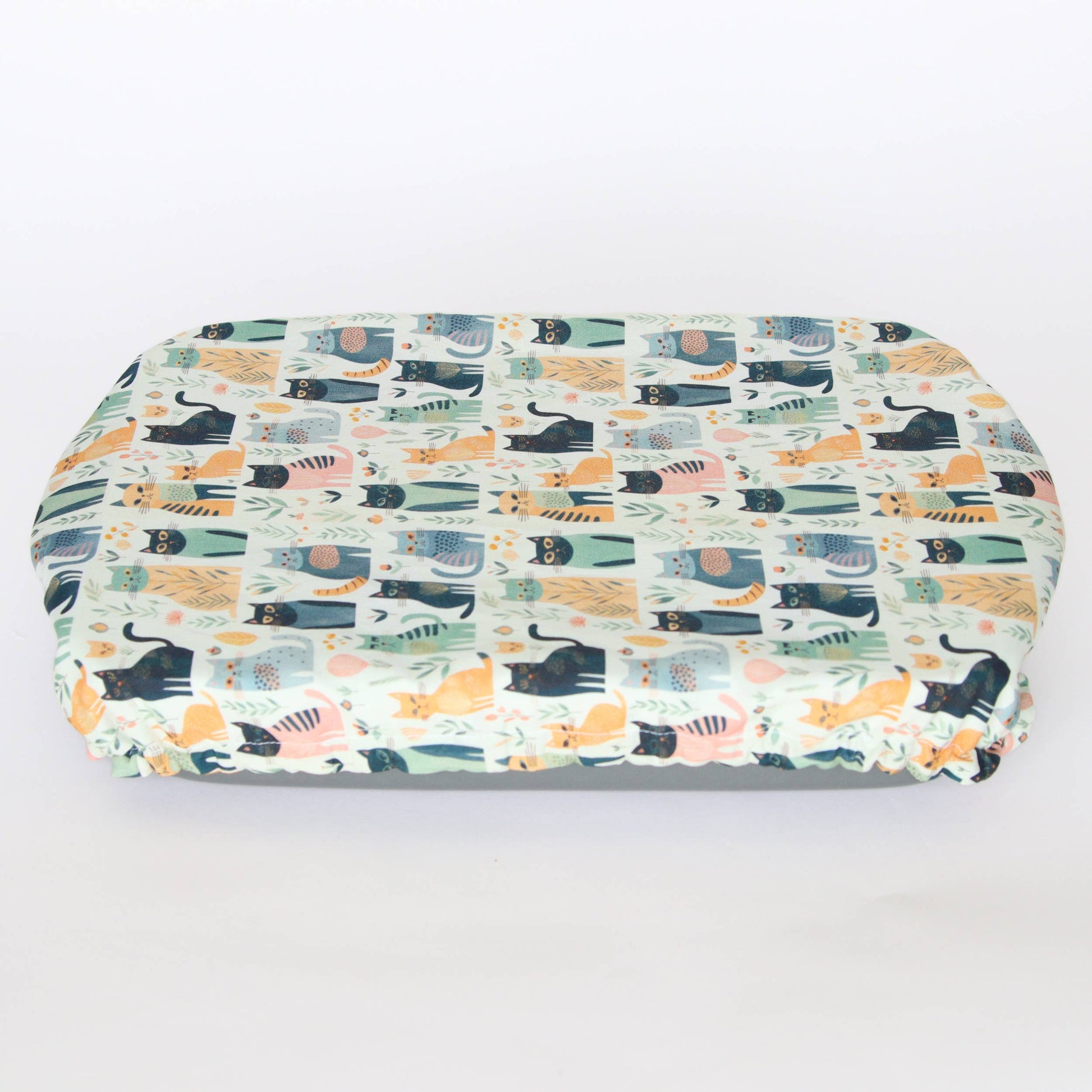 light coloured casserole cover with cat prints covering a dish