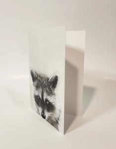 raccoon head on the bottom a card that is partially open