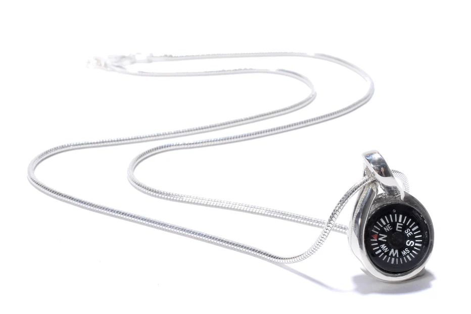 silver SW Compass Necklace & silver chain on white background