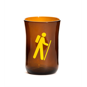 brown glass cup with yellow symbol of a hiker