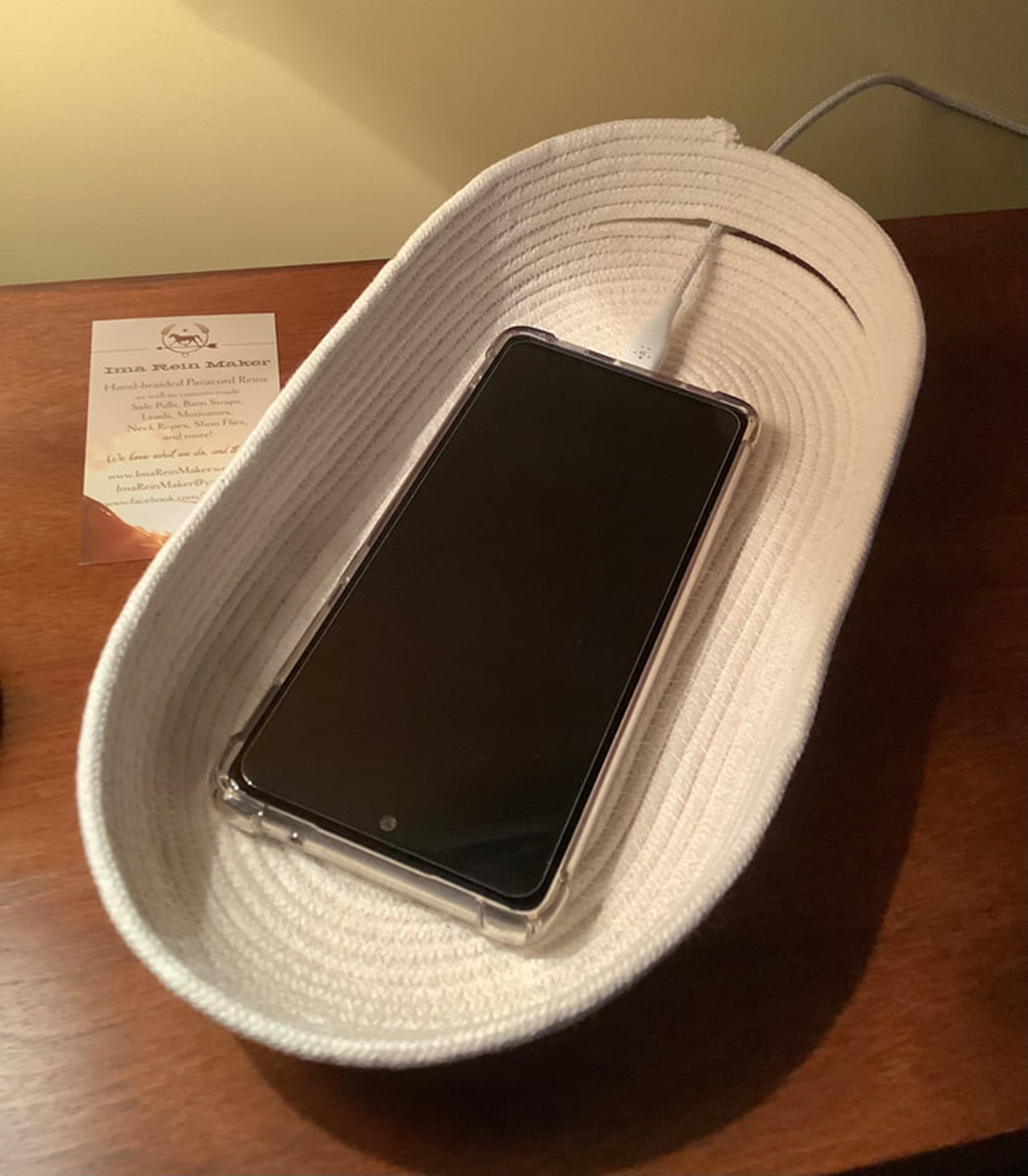 natural coloured tray made out of rope  sitting on table with cell phone