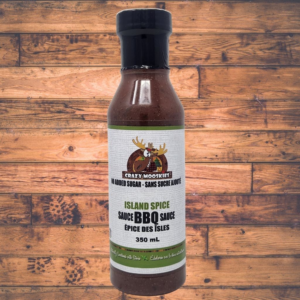 Bottle of Crazy Moose Island Spice Sauce BBQ on a wooden background
