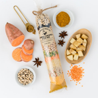 Clear bag filled with spices & dry ingredients surrounded by fresh ingredients