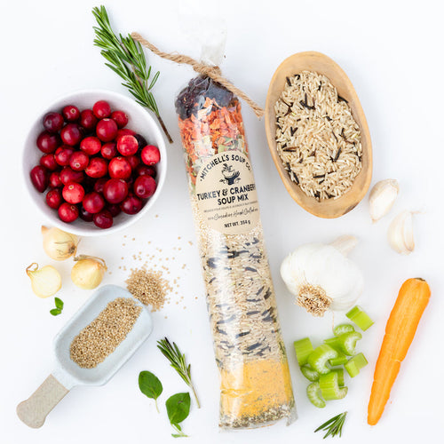 bright red cranberries & rice beside a bag full of a variety of ingredients