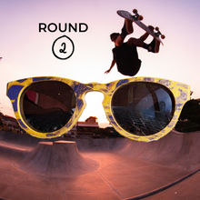 Load image into Gallery viewer, Wooden sunglasses in the foreground with skateboard park and boarder in background
