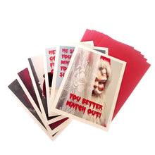 Load image into Gallery viewer, Creepy Santa Assorted cards fanned out with red envelopes behind them
