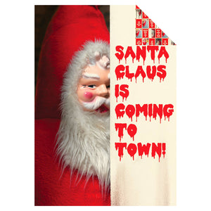 Creepy Santa Coming To Town written in red with creepy Santa head peeking from behind