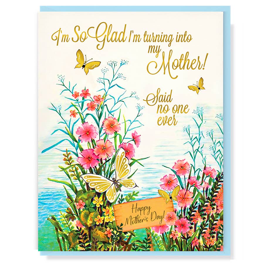 colourful flowers and foliage beside a body of water with butterflies fluttering around