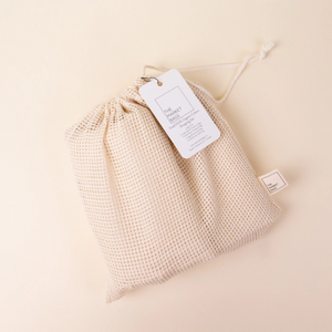 mesh produce bag with something in it with white tag
