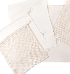 close up of natural coloured mesh and muslin produce bags on a white background