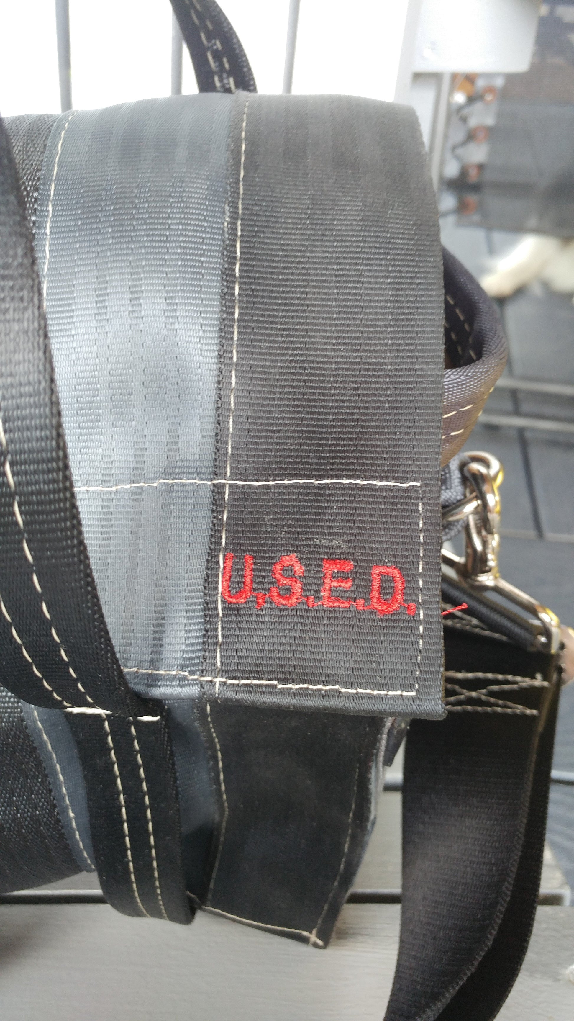 close up look at the red U.S.E.D. red stitching on the front of the bag