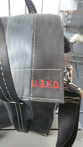 close up look at the red U.S.E.D. red stitching on the front of the bag